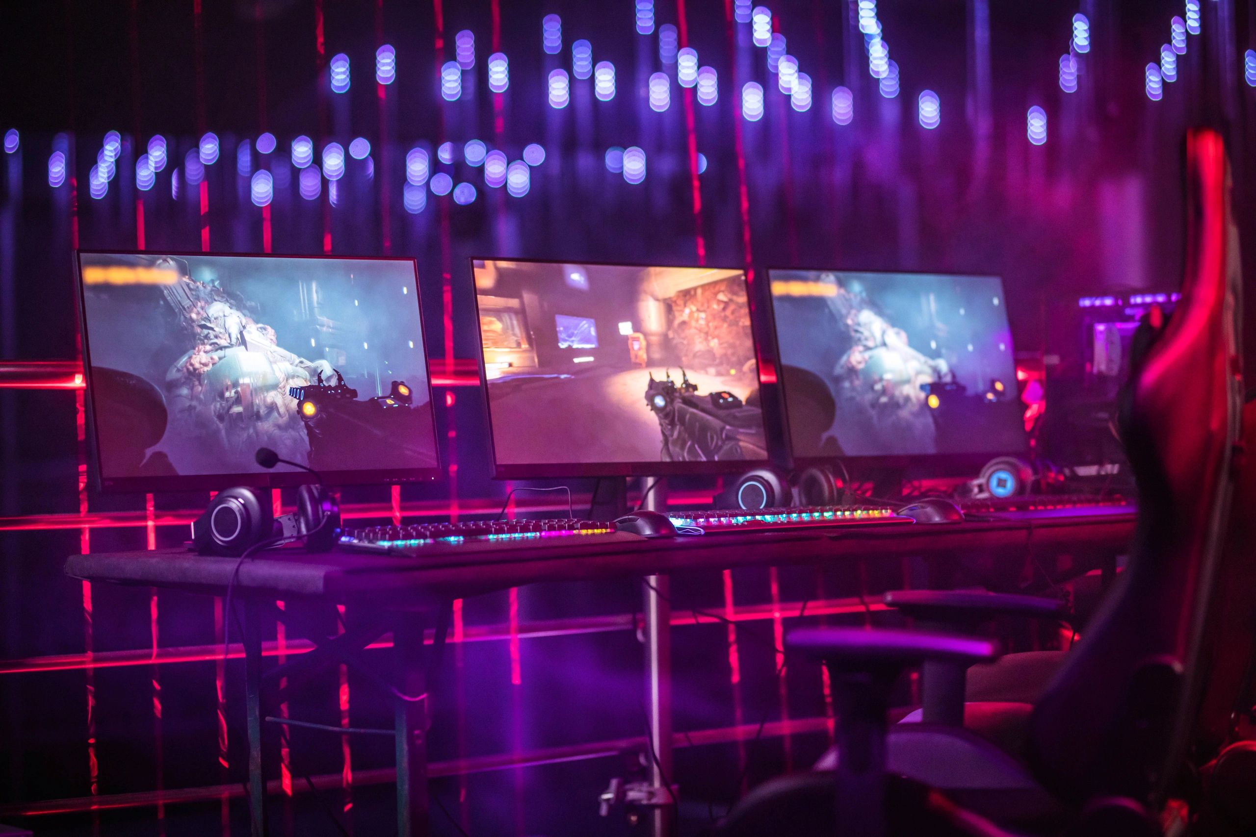 RGB-lit gaming PC setup in a neon-lit room
