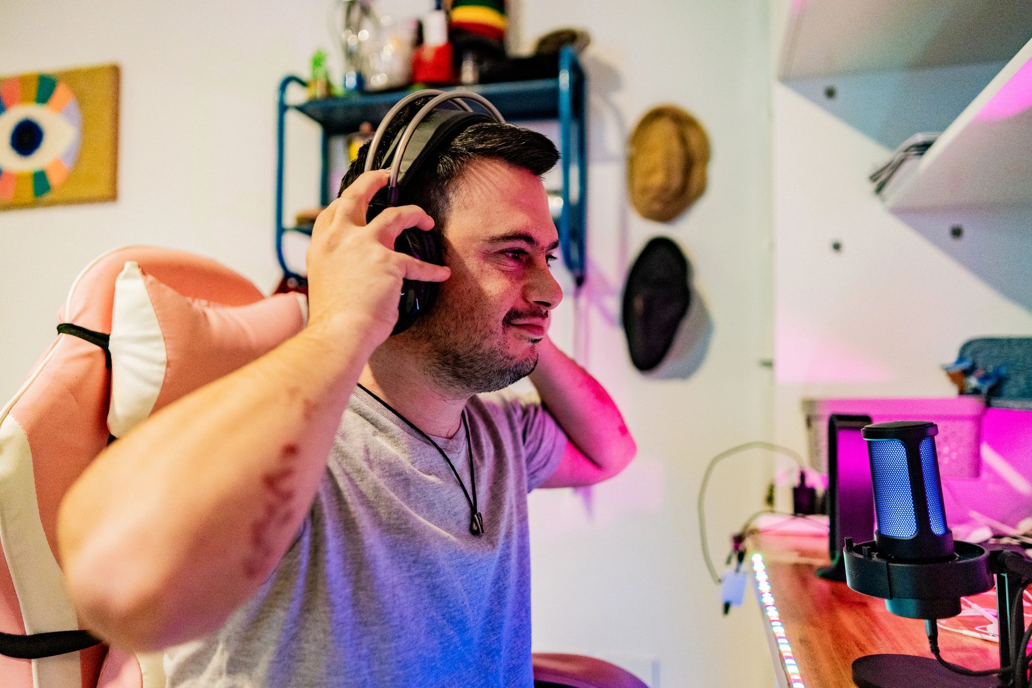 Gamer wearing headphones in a colorful gaming room
