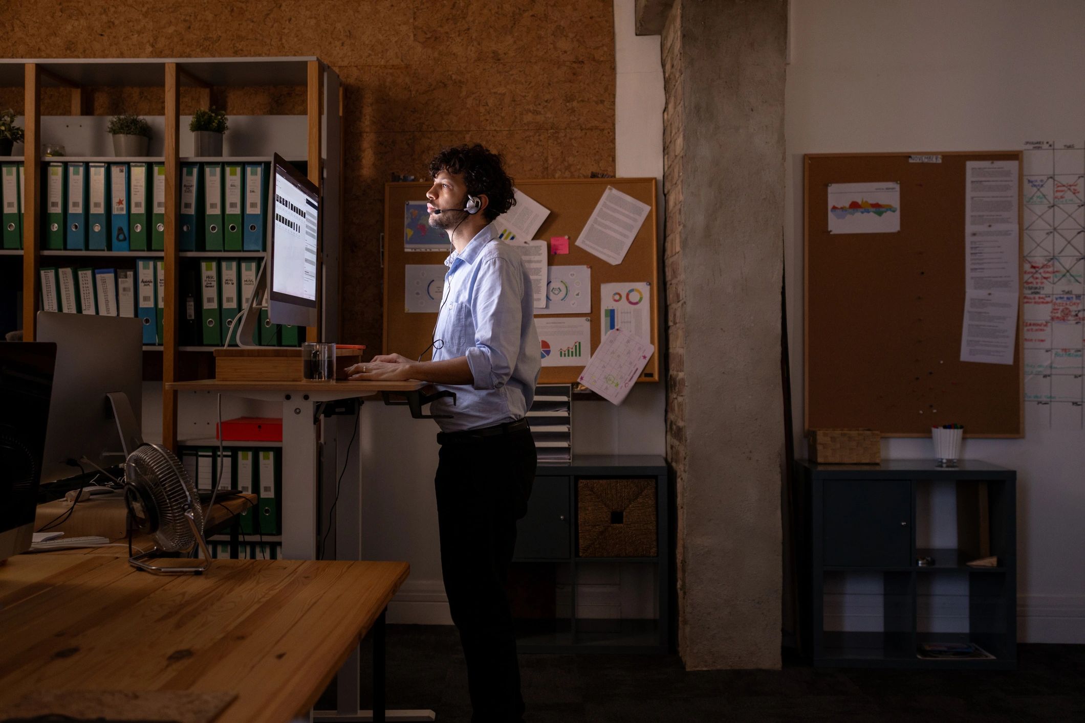 Person working at computer with headset
